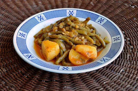 Fresh green beans with tomato sauce and potatoes. Greek food.