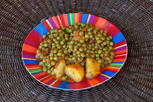Fresh green peas with tomato sauce and potatoes. Greek food.