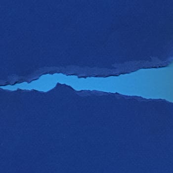 Torn blue paper background resembling flowing river. Grunge design element.
