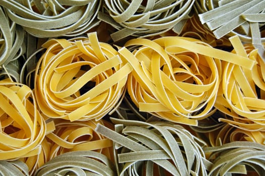 Flavors of fresh tagliatelle pasta. Italian food background.