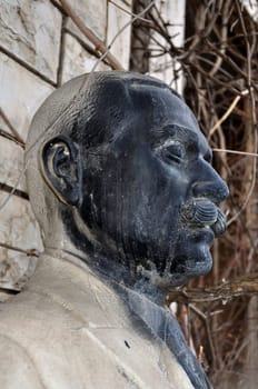 Vandalized marble statue of unidentified man with mustache at the abandoned house of sculptor Nikolaos Pavlopoulos, Athens Greece, February 3, 2012.