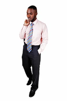 A black business man standing for white background with his suit jacket.over his shoulder..