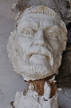 Plaster sculpture ancient god Zeus broken statue head in the abandoned studio of sculptor Nikolaos Pavlopoulos in Athens Greece, February 3, 2012.