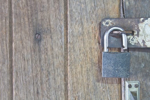 old padlock on an old wooden door