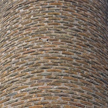 Curved brick wall background texture. Factory chimney detail.
