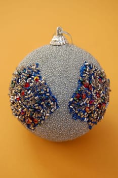 Cristmas decoration silver bauble with glitter seasonal background.