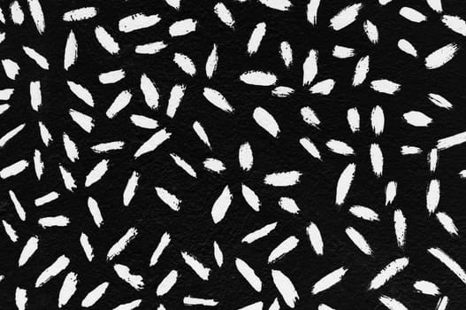 White paint strokes abstract lines pattern on black textured surface.