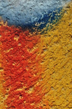 Paint smudged textured plaster and gravel wall abstract background.