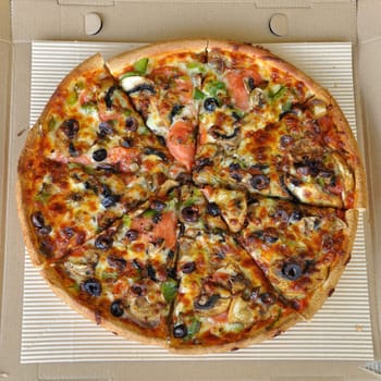 Pizza with pepperoni, mushrooms, pepper, and olives. Italian fast food background.