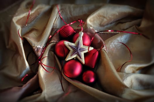Red baubles and golden star. Christmas ornaments background.