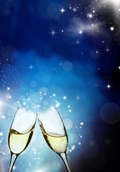 Glasses with champagne against holiday light and snowflakes