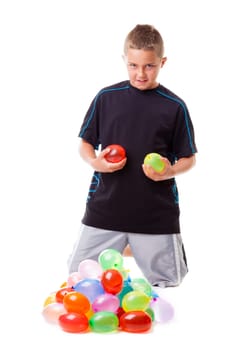 Boy with a pile of water balloons isolated on white background