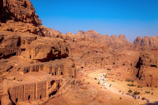 View of desert and ancient tombs carved in the rock in Petra, Jordan