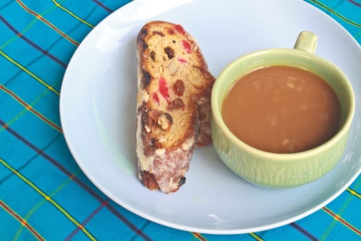 Fruitcake with raisin and Seasoning on table, with hot coffee
