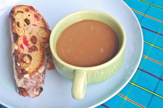 Fruitcake with raisin and Seasoning on table, with hot coffee