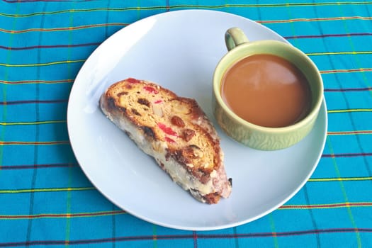 Fruitcake with raisin and Seasoning on table, with hot coffee