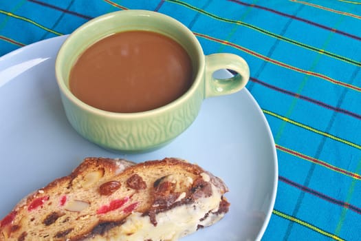 Fruitcake with raisin and Seasoning on table, with hot coffee