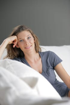 Portrait of beautiful young woman relaxing on couch