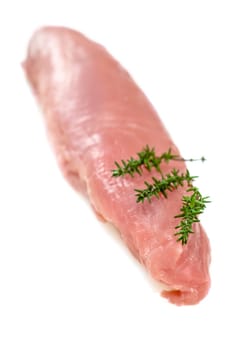 Raw pork meat with thyme in portrait format