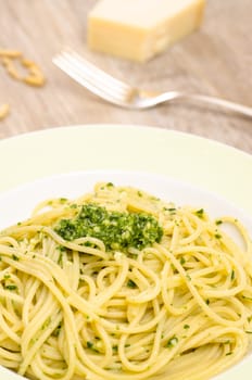 Spaghetti with ruccola pesto and pine nuts and Parmesan cheese