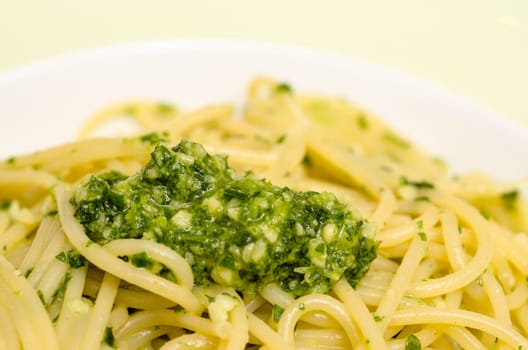 Close-up of green ruccola pesto with spaghetti