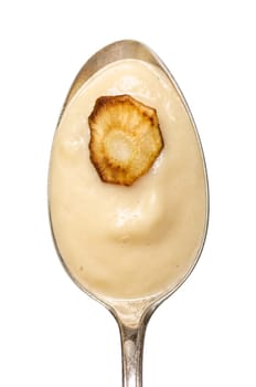 Spoon of parsnip soup and a slice of fried parsnip