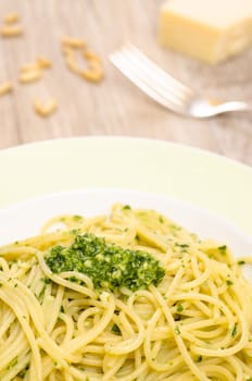 Plate of spaghetti and pesto on a table