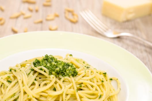 Spaghetti with green pesto on a plate