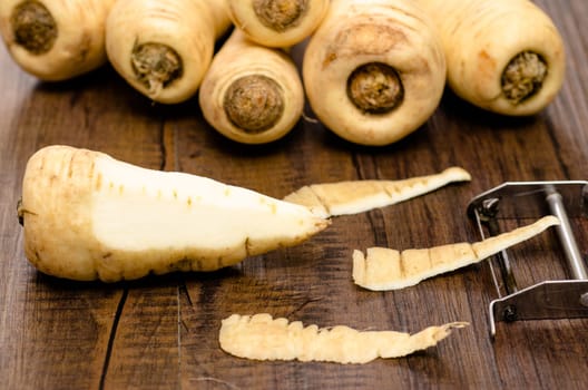 Root vegetables Parsnip with peeler and peel