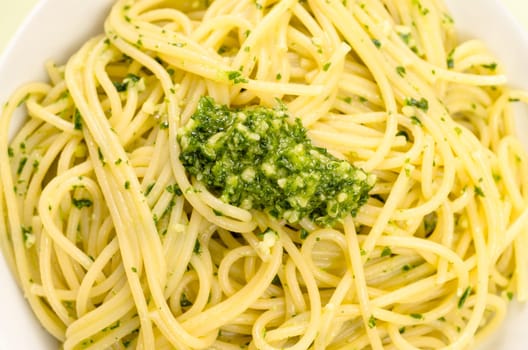 Spaghetti with green pesto and pine nuts