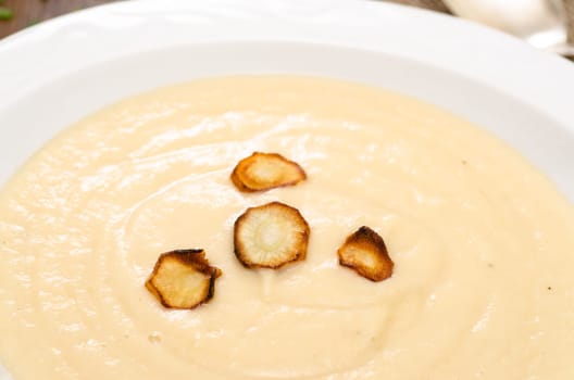 Fried parsnips on a soup in a plate