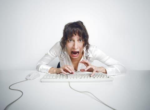 Funny and quite grotesque frontal portrait of a scared woman at her office desk