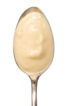 Silver spoon with light parsnips soup