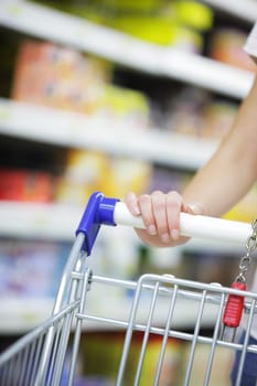 Woman with shopping cart, close up