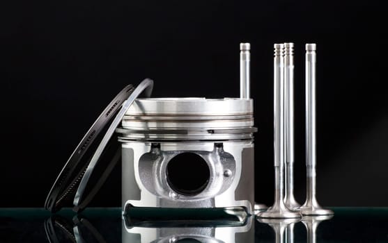 Pistons and accessories isolated on black background