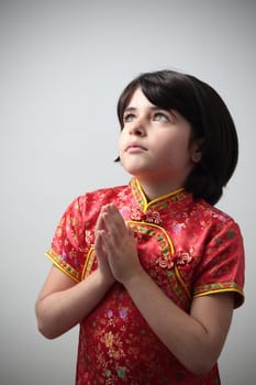 Details of a little caucasian girl dressed in a Chinese dress.