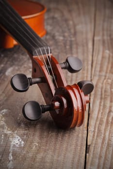 Close up of a violin on old wood background