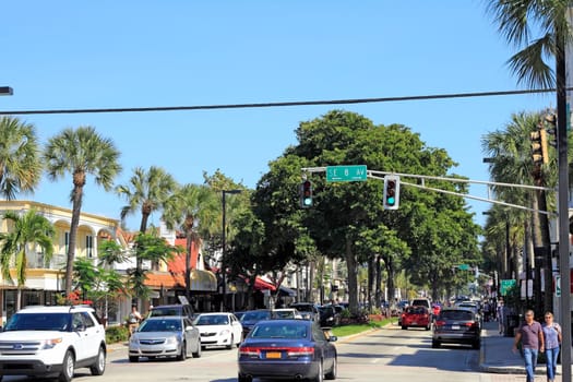 FORT LAUDERDALE, FLORIDA - FEBRUARY 3, 2013: People walk and drive along tropical and very well known upscale shopping, dining and entertainment district on east Las Olas Boulevard.