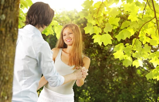 a young couple in love having fun in the park