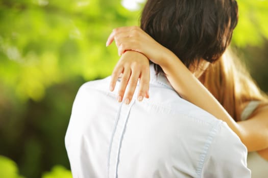 a young couple of lovers kissing in the park