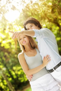 a young couple in love walking in the park