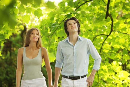 a young couple in love walking in the park