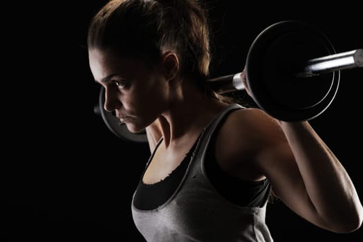 Young woman lifting weights