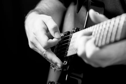 Close up on hands playing on guitar