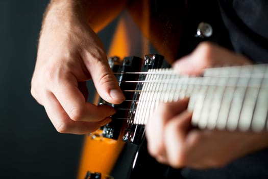 Close up on hands playing on electric guitar