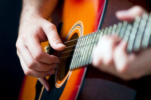 Close up on hands playing on folk guitar