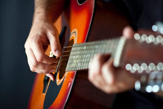Close up on hands playing on folk guitar