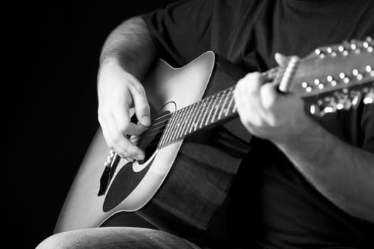 Close up on hands playing on folk guitar