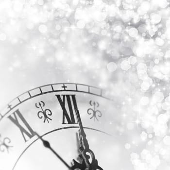 Old clock against holiday lights
