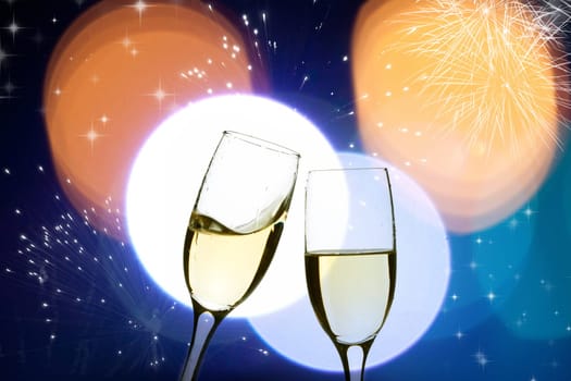 Two glasses of champagne with colorful lights in the background